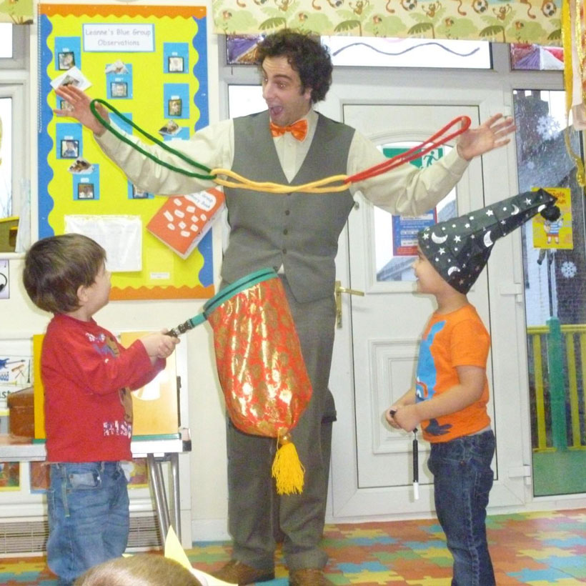 The Party Guy performing a magic show for children at a nursery